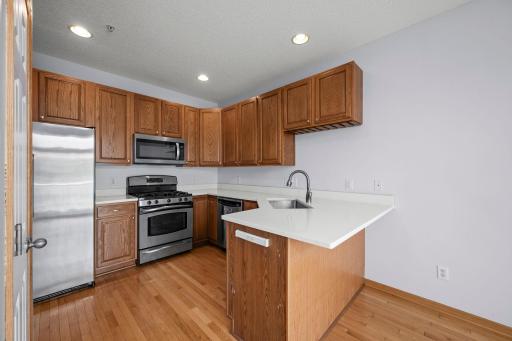 Ample counter space and a deep double sink make meal preparation a breeze in this well-appointed kitchen.