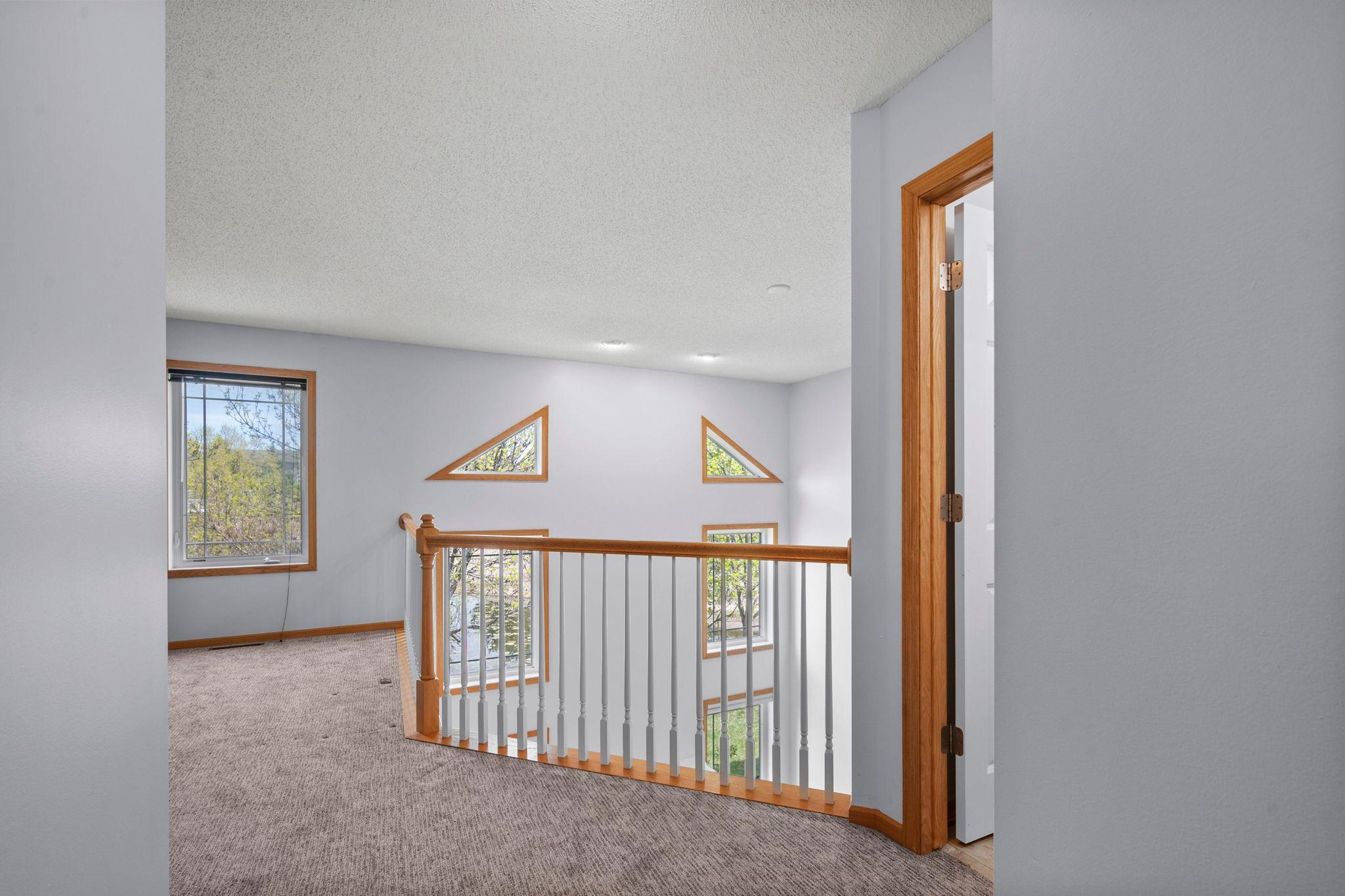 The open loft provides a unique architectural perspective and additional living space on the second floor.