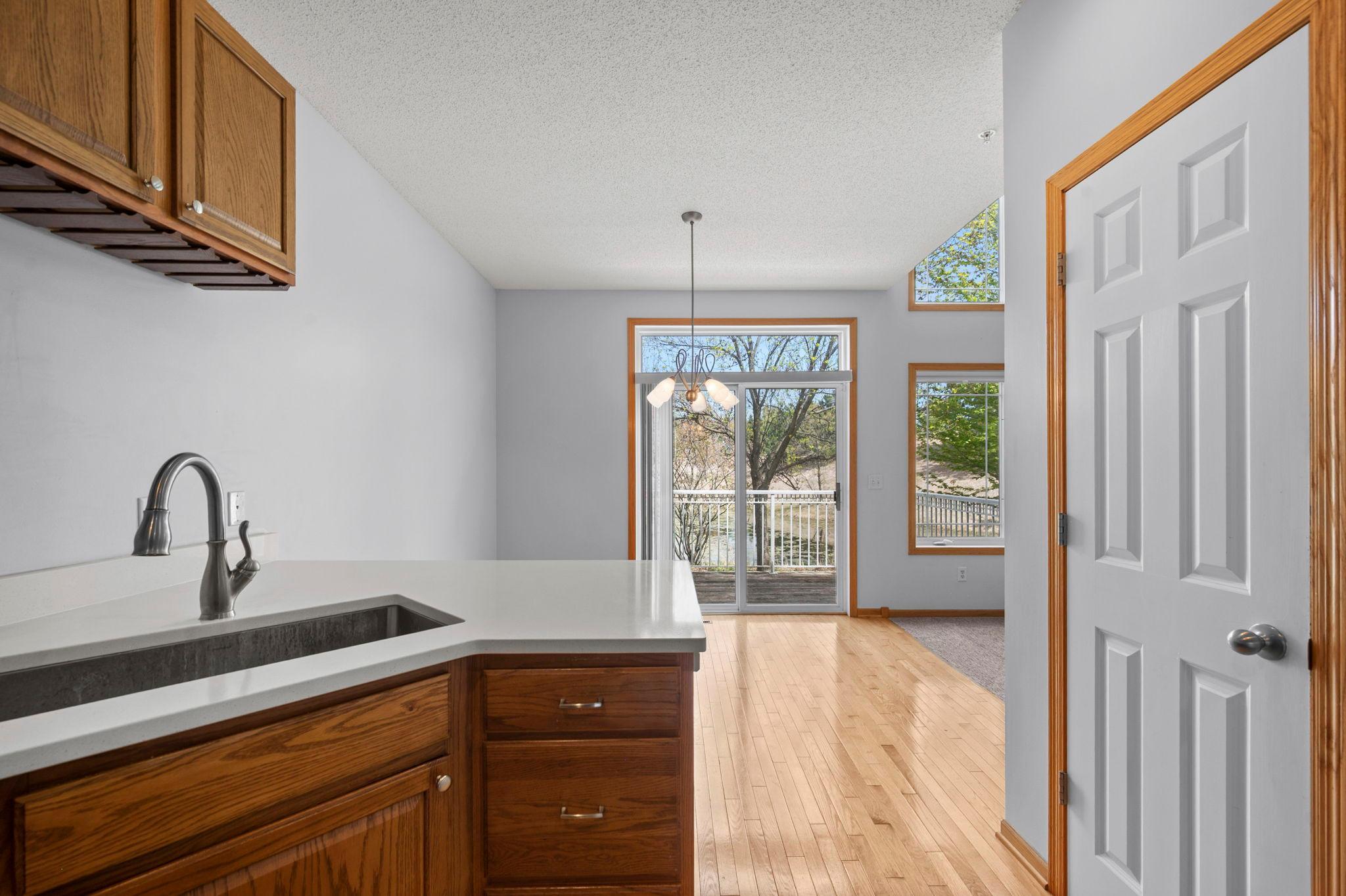 From the kitchen sink, enjoy an open view into the dining area and out toward the private deck.