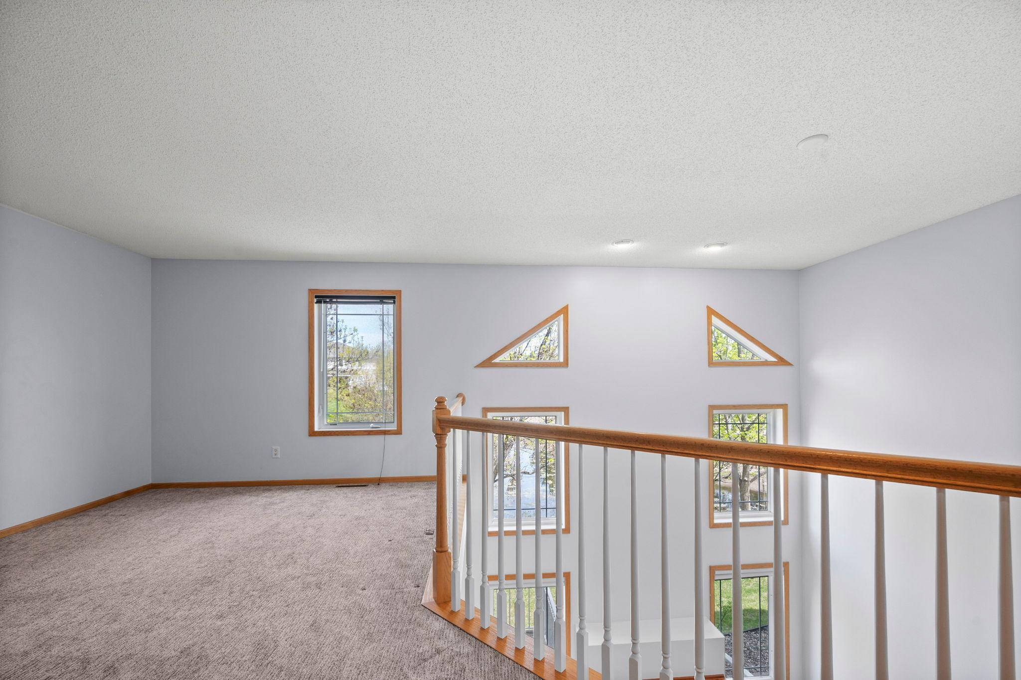 A versatile loft space overlooks the great room, perfect for a home office, reading nook, or play area.
