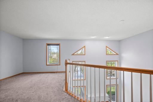 A versatile loft space overlooks the great room, perfect for a home office, reading nook, or play area.