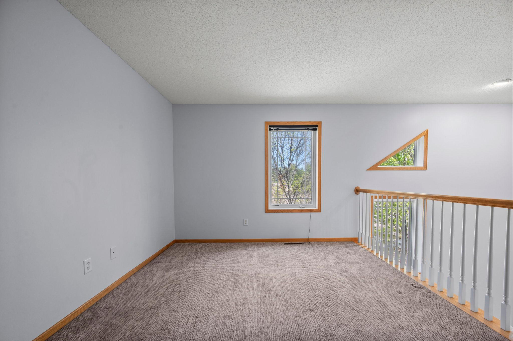 Bright and open, the loft space provides a perfect transition between the upper-level bedrooms.