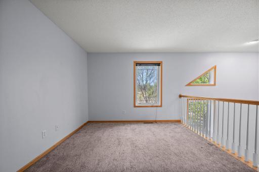 Bright and open, the loft space provides a perfect transition between the upper-level bedrooms.