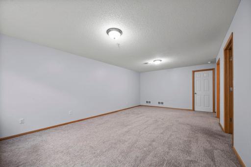 Wide-angle view of the finished lower level showcasing the versatile open floor plan.