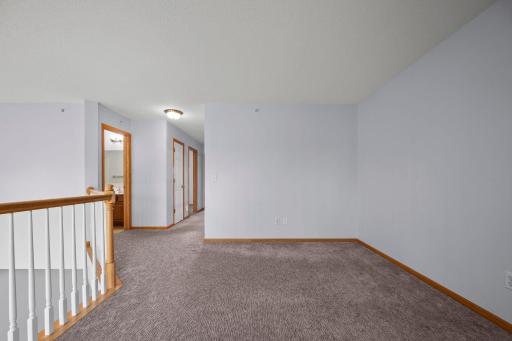 This wide-angle shot of the loft emphasizes the generous square footage available for a home office or media space.