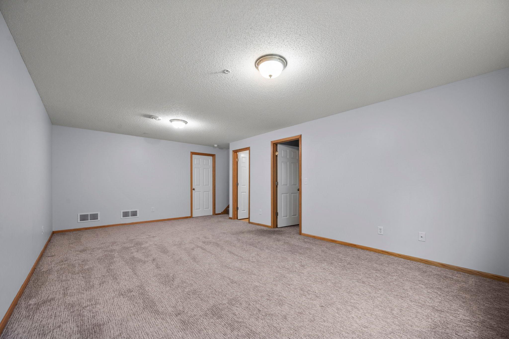 This flexible lower-level living space is perfectly suited for a media room or secondary lounge area.