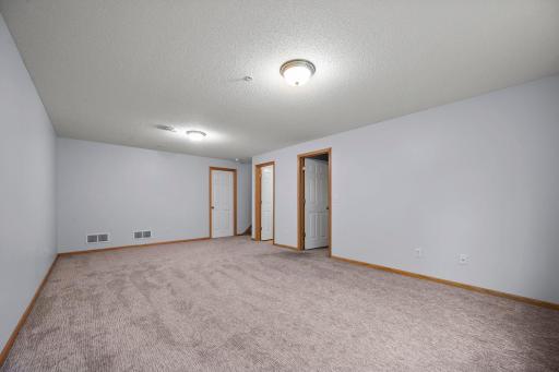 This flexible lower-level living space is perfectly suited for a media room or secondary lounge area.