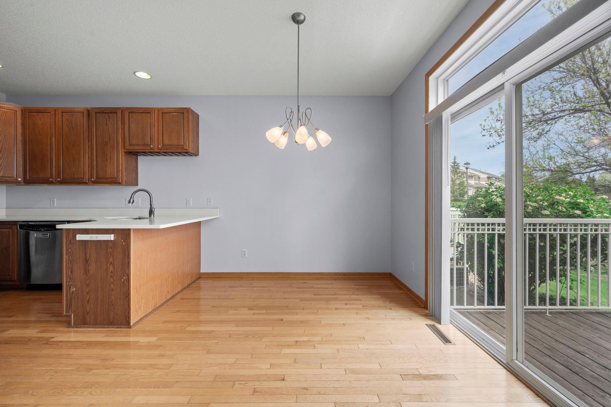 Charming dining area with classic hardwood floors and sliding glass doors that lead out to the private deck.