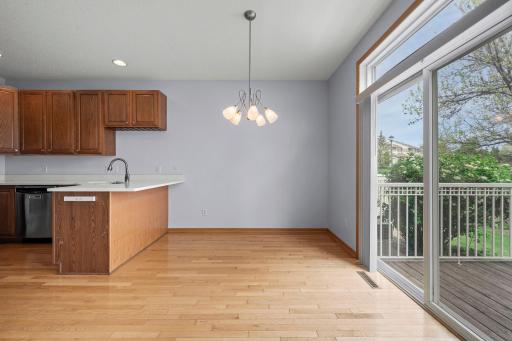 Charming dining area with classic hardwood floors and sliding glass doors that lead out to the private deck.