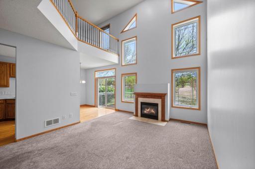 Bright and airy living space offering scenic views of the surrounding landscape and access to the outdoor deck.