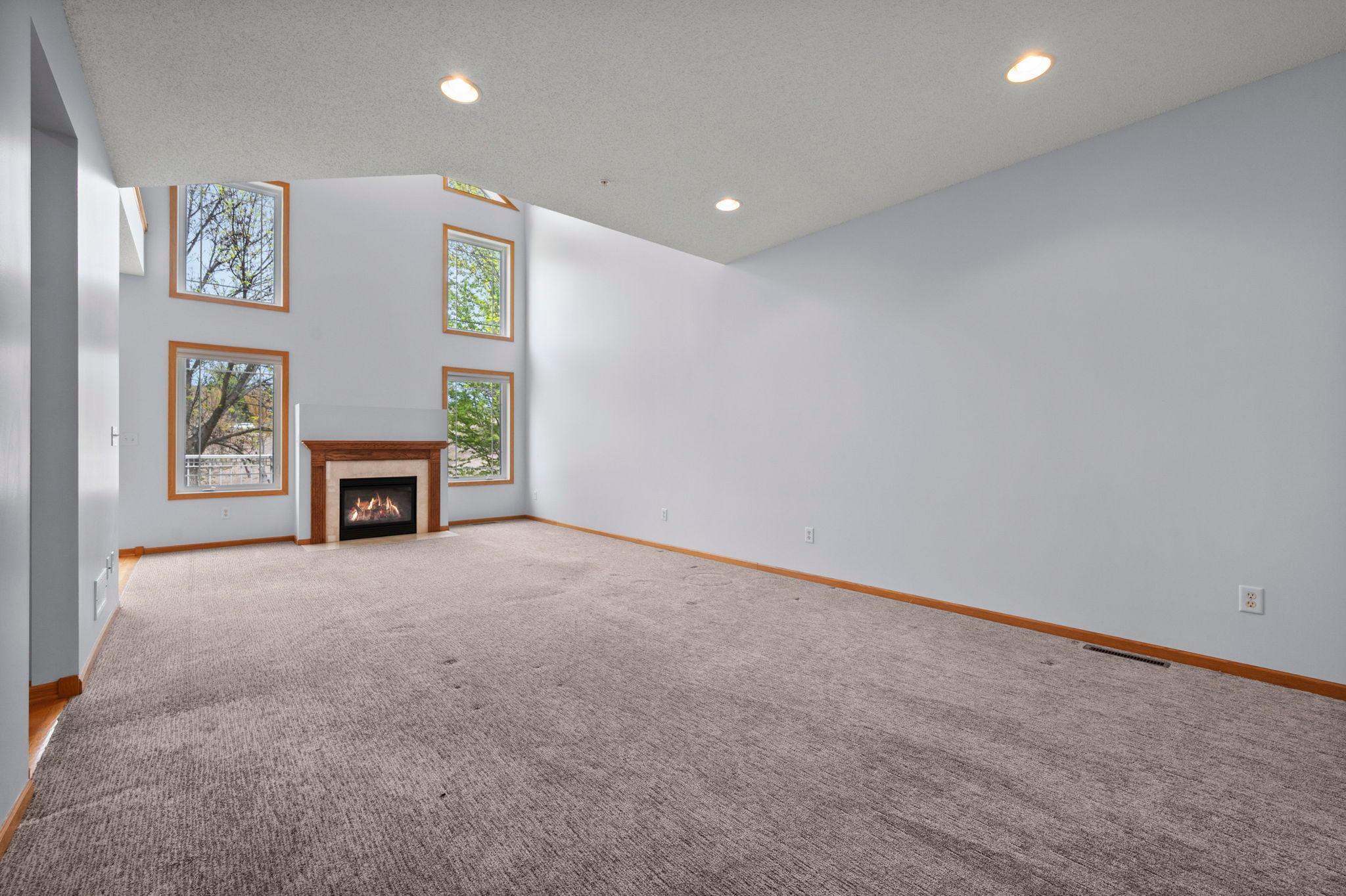 Spacious main floor living area bathed in natural light from the large stacked windows.