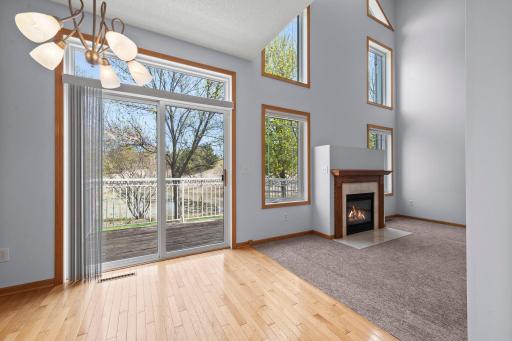 Beautiful view from the dining area toward the fireplace, showcasing the impressive scale of the two-story windows.