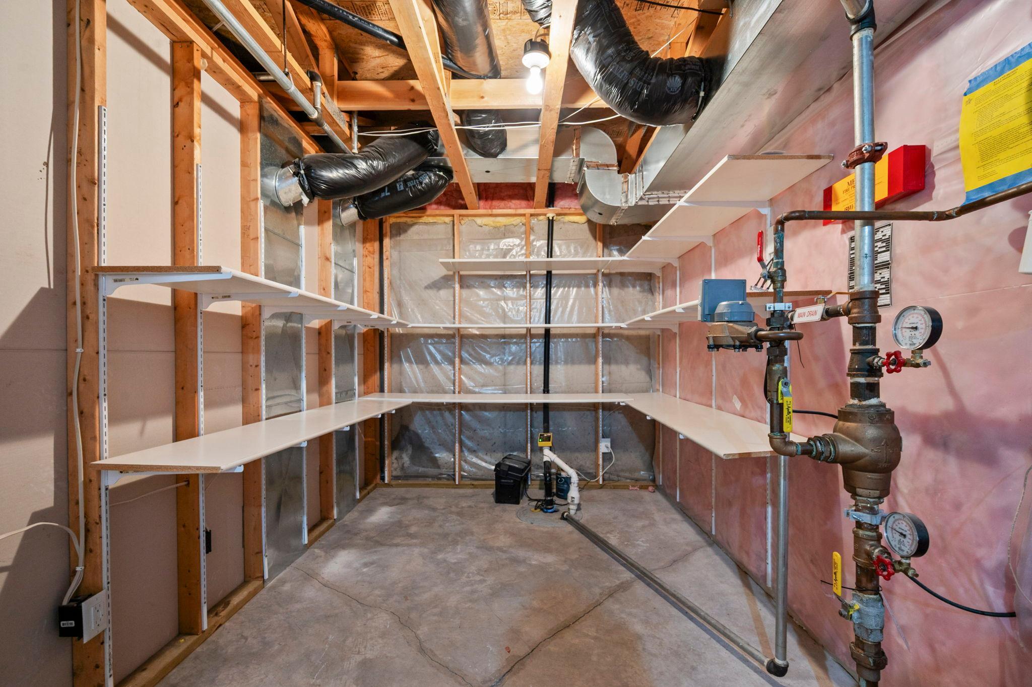 The unfinished portion of the basement provides a massive amount of storage space with built-in shelving.