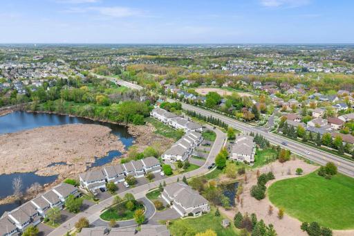 Expansive aerial perspective showcasing the property's proximity to scenic wetlands and lush green spaces.