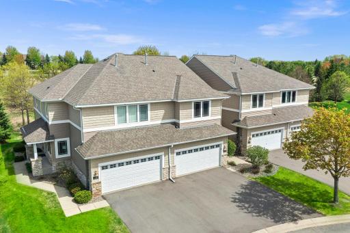 High-angle perspective showing the expansive driveway and the home's clean architectural lines.