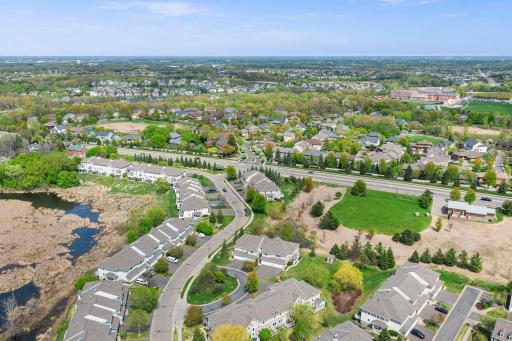 High-angle shot highlighting the quiet residential neighborhood and manicured community landscaping.