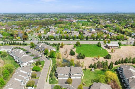 Bird's-eye view of the neighborhood's open green fields and well-maintained walking paths.