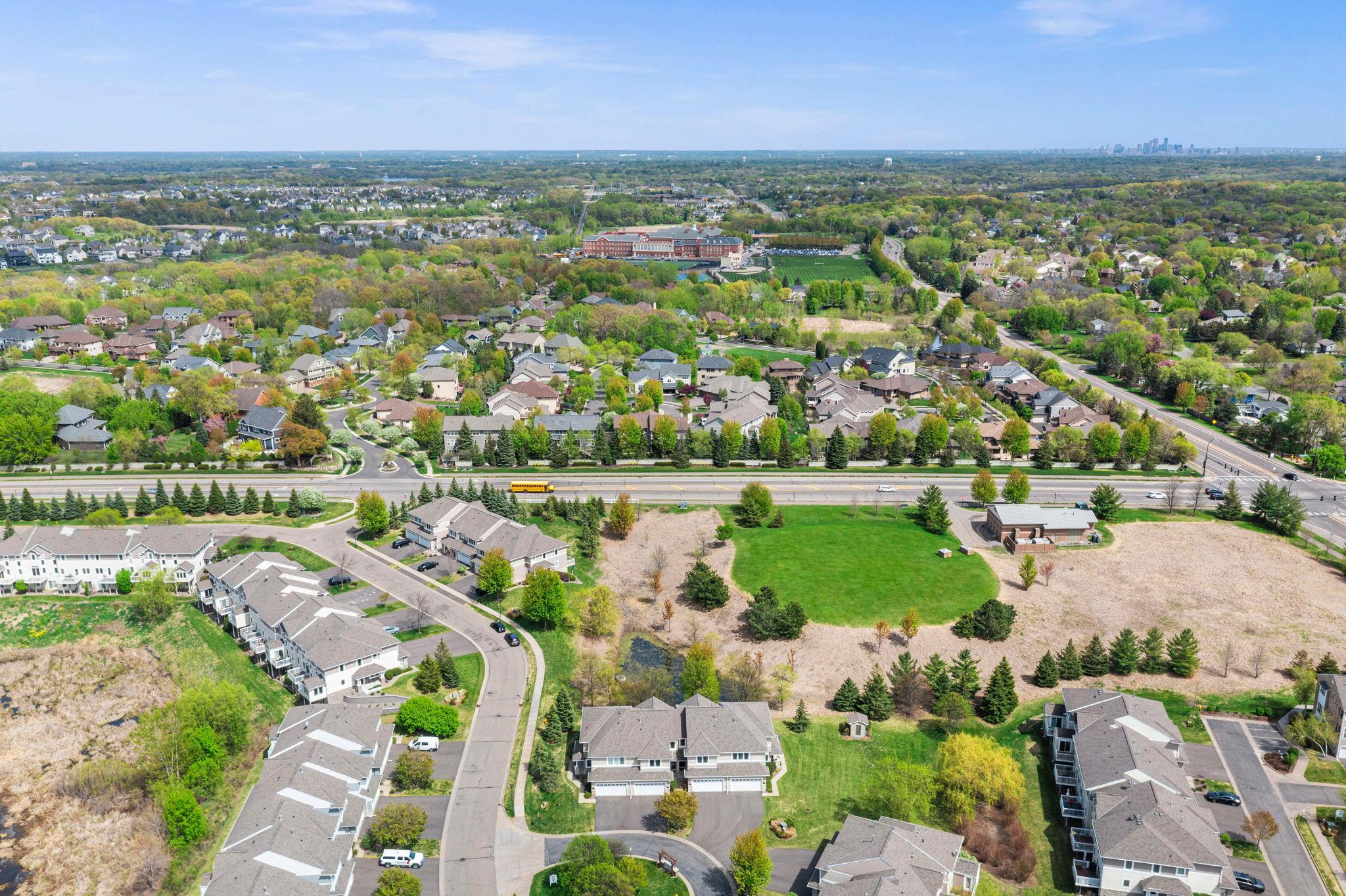 Detailed aerial shot focusing on the property's exterior design and its integration into the vibrant community.
