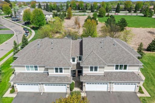 Top-down view of the rooflines and surrounding mature trees, emphasizing a private neighborhood feel.