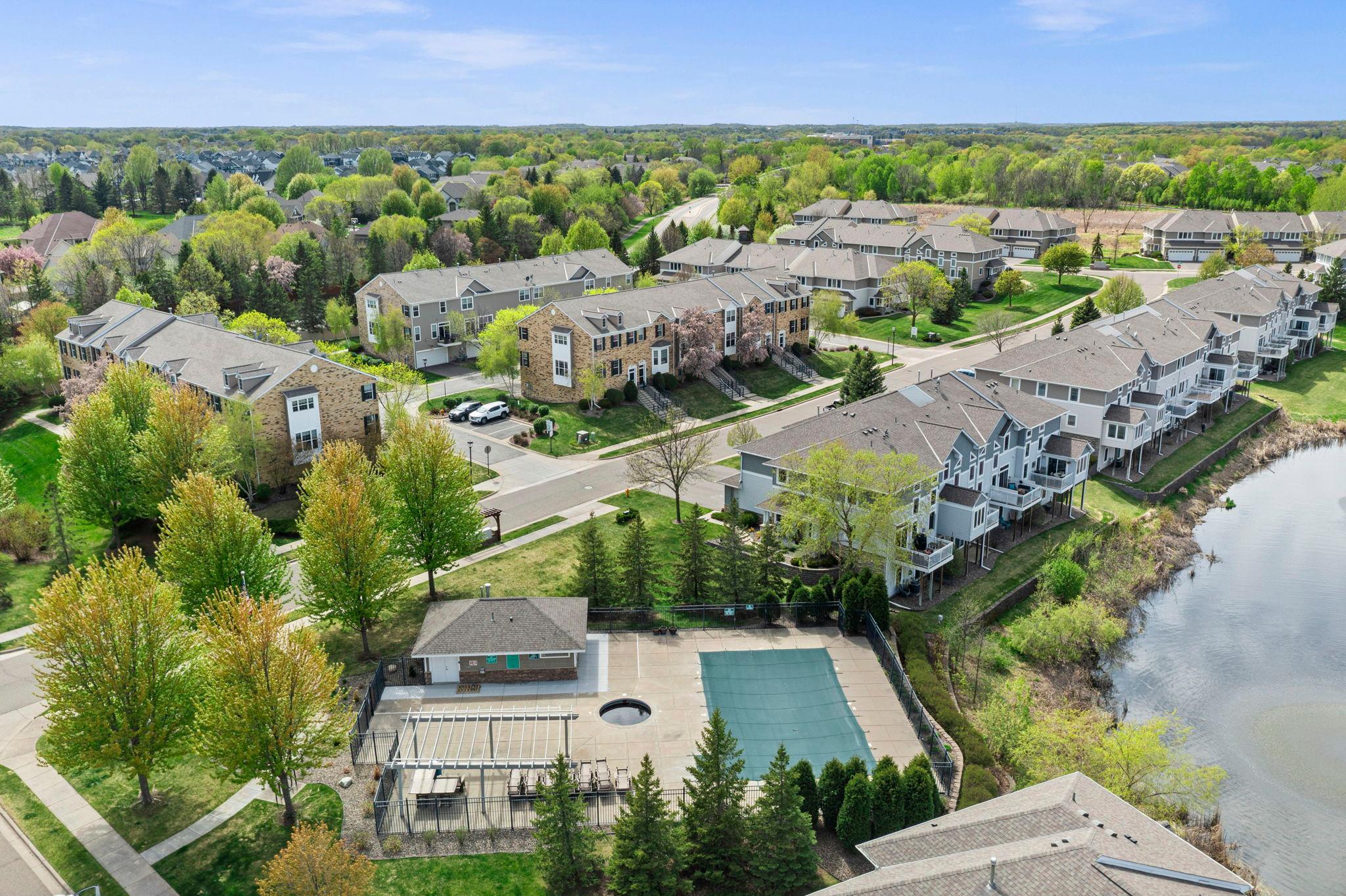 Residents enjoy premium amenities, including a private community pool and lounge area overlooking the water.