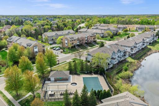 Residents enjoy premium amenities, including a private community pool and lounge area overlooking the water.