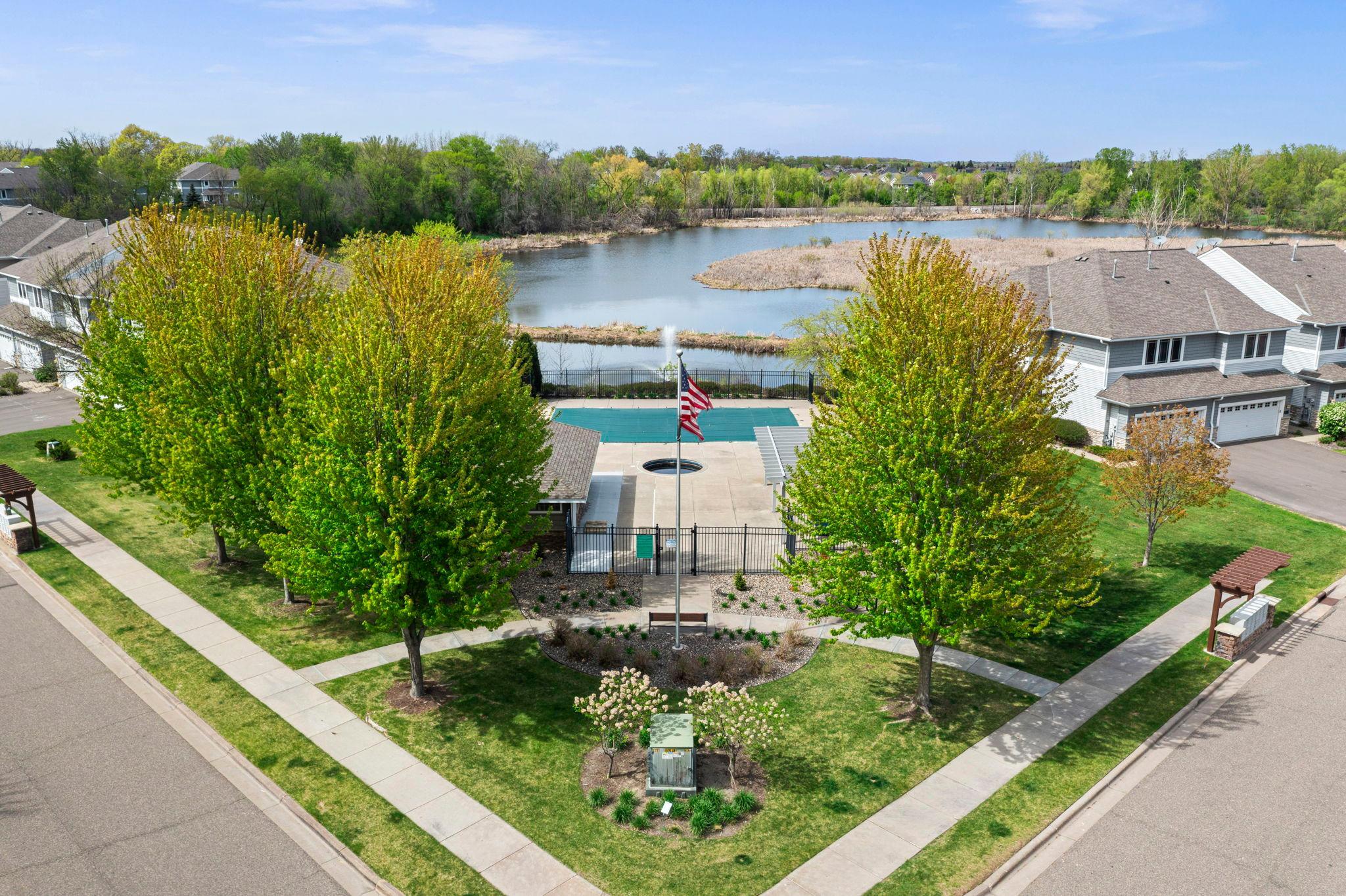 Beautifully landscaped common areas and walking paths connect the residential units to the community amenities and serene water views.