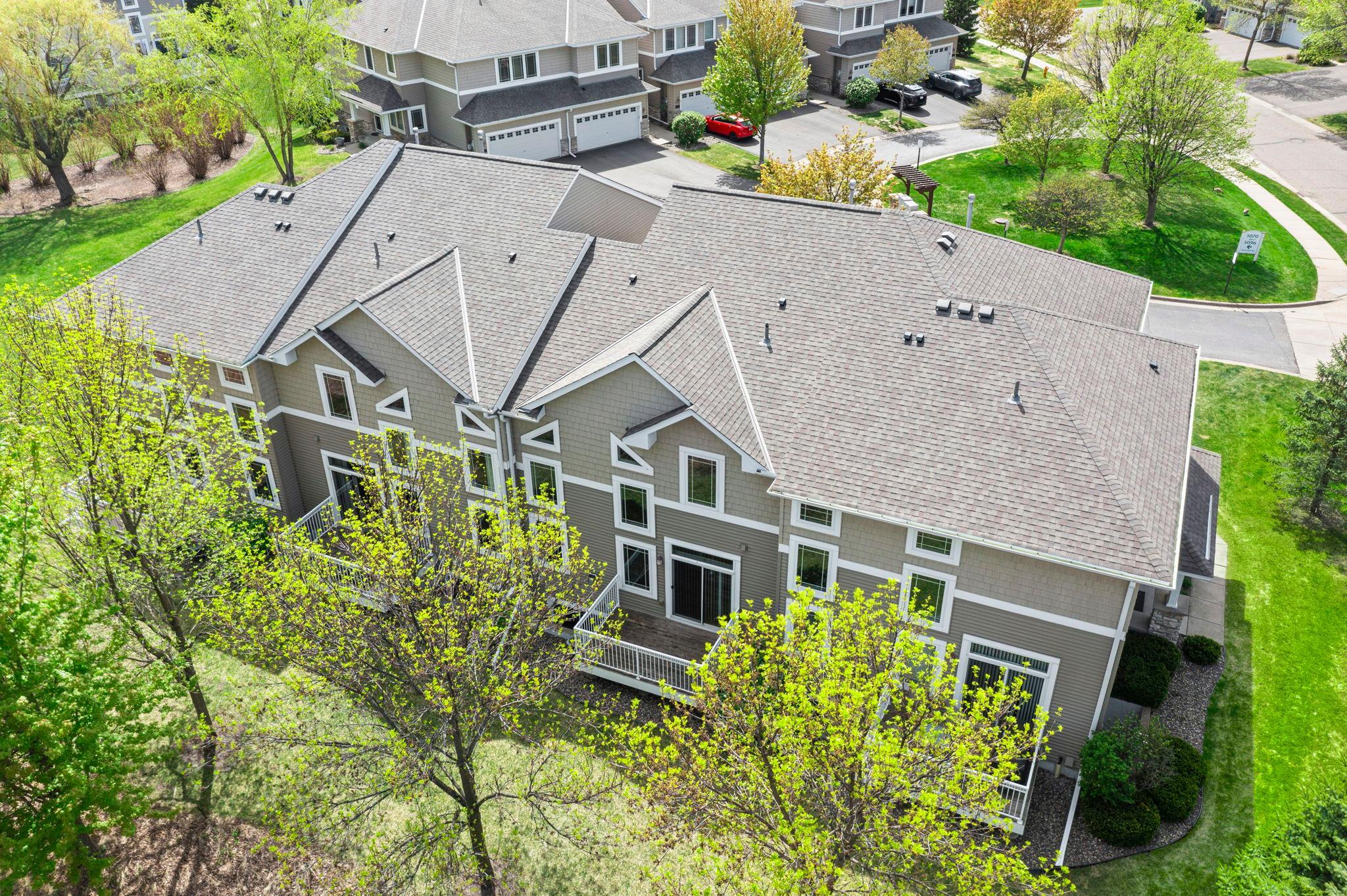 Aerial view highlighting the architectural harmony and expansive green lawns shared by the community residents.