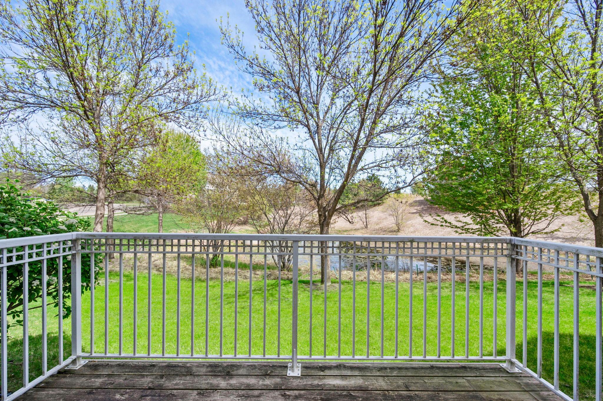 Relax on the private wood deck and enjoy the serene views of the pond and lush surrounding landscape.