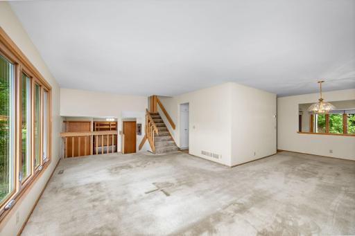 Living room connected to foyer, kitchen, and dining room