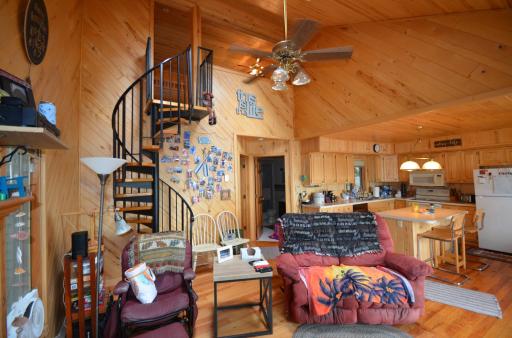Spiral staircase to upper level bedroom, bath, and walk in closet