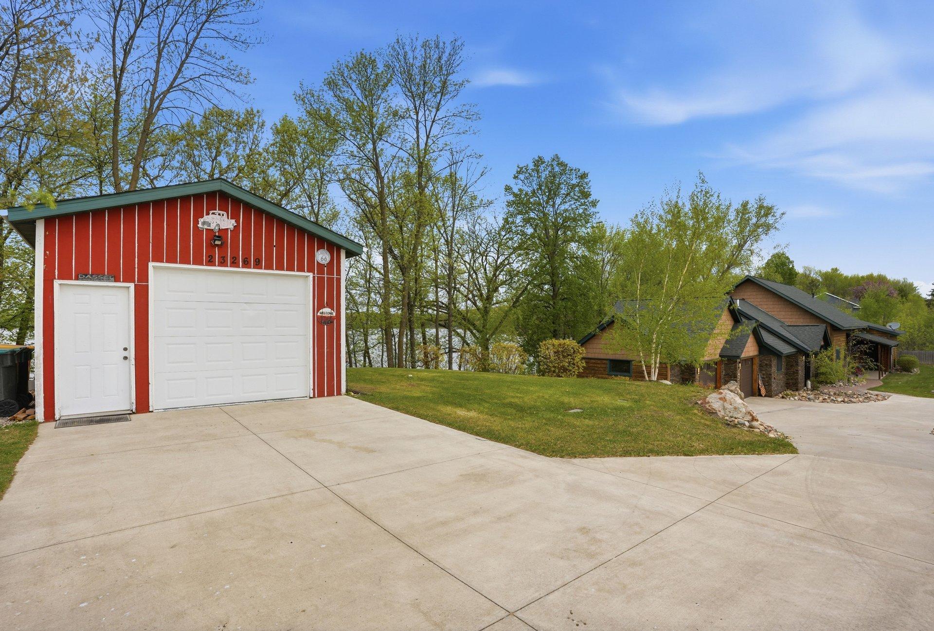 The concrete drive starts by the detached garage and goes to the front of the home