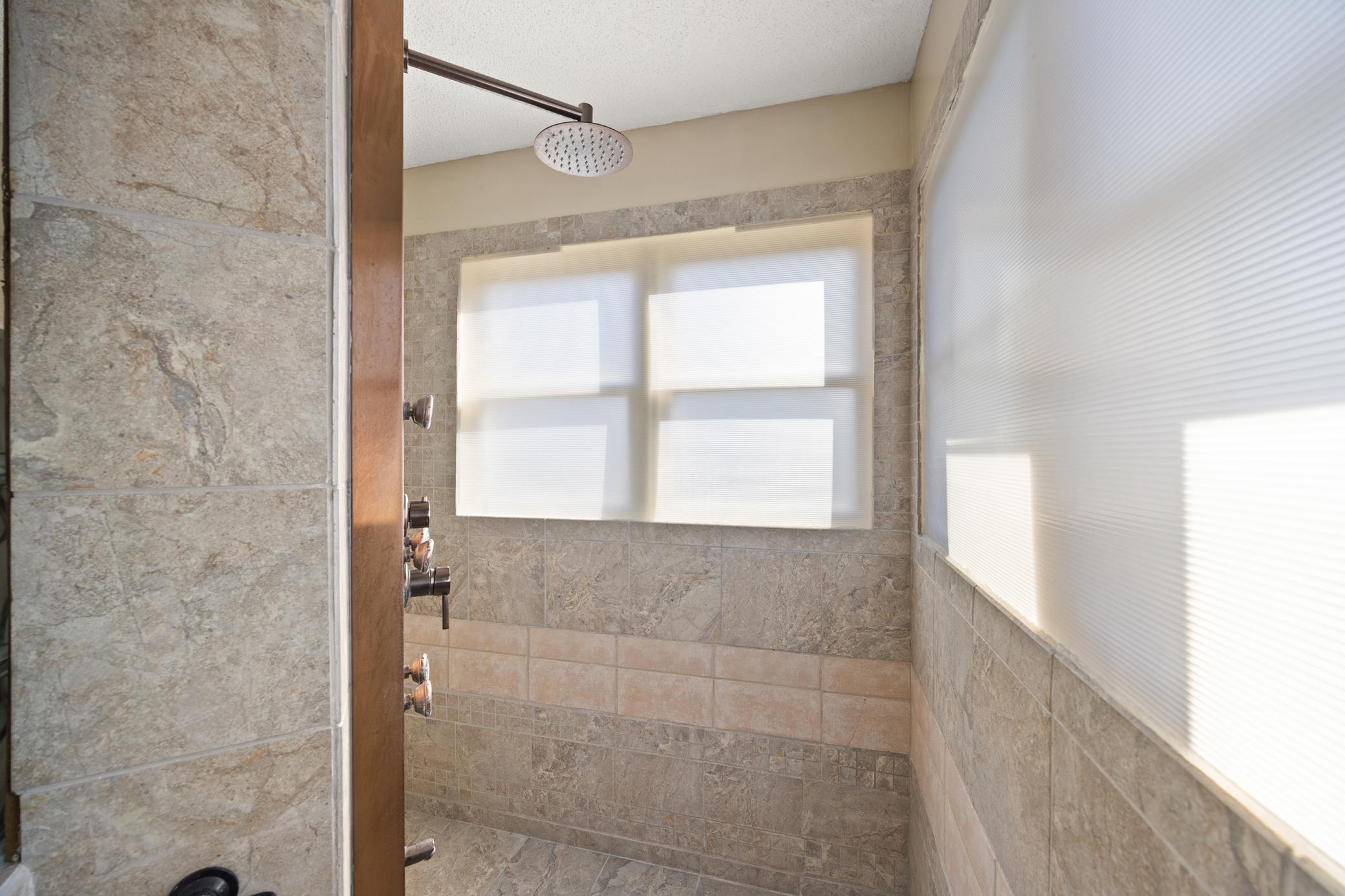 Large walk in shower with tile throughout