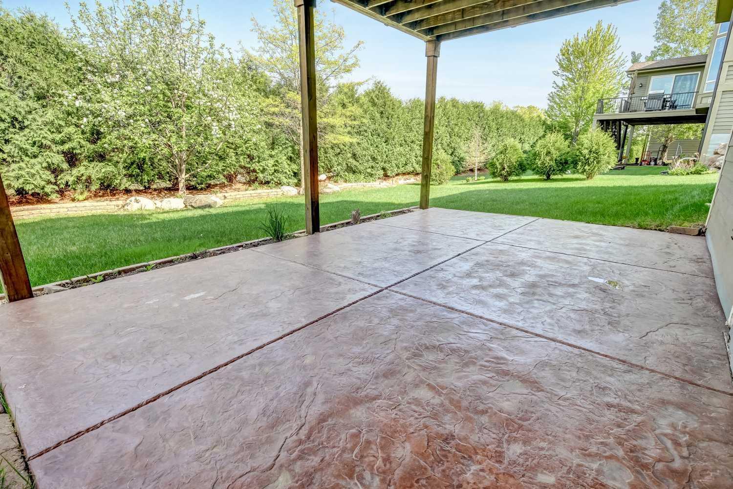 Stamped concrete patio below deck