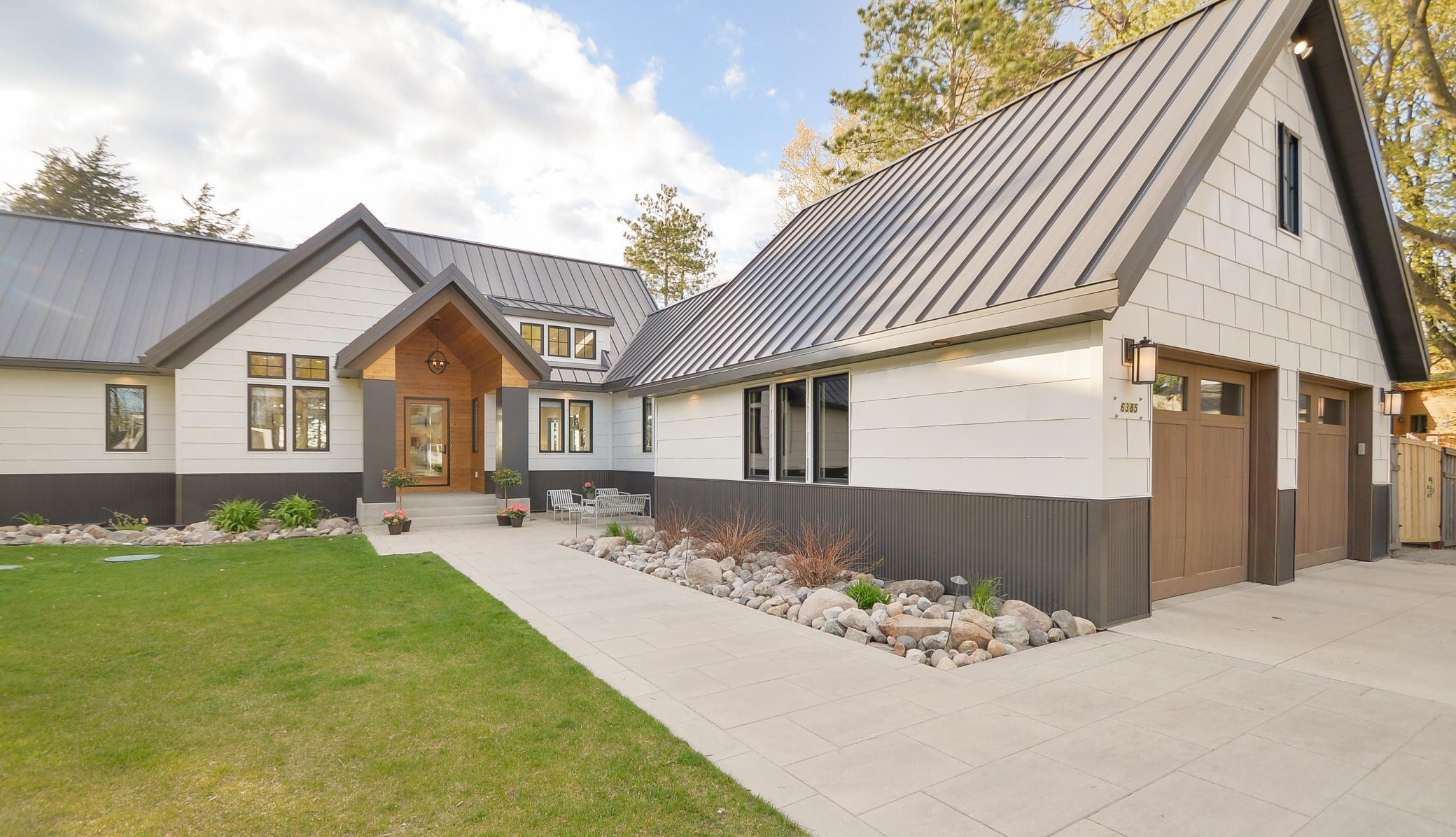 Impressive cedar front porch with vaulted ceiling welcomes you home!