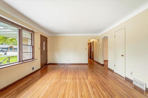 From the living room you can see down the hall to the bedrooms and the dining room is to the right.