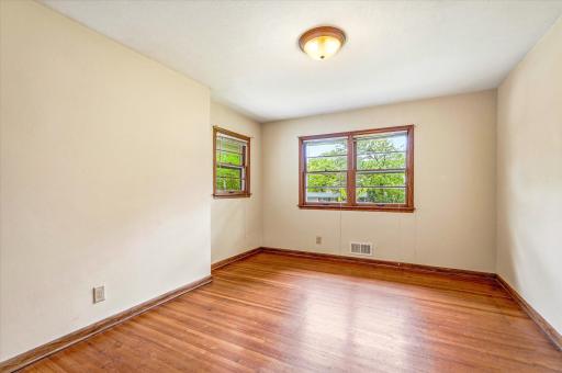 Main floor bedroom 3 with front yard views.