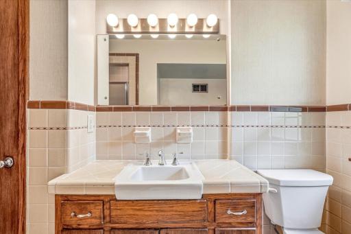 The original vanity with tile counter top and lots of storage