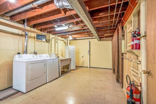 The laundry space is very generous with lots of storage. There is a toilet behind the screen on the other side of the sink. The could easily be made into another private bathroom.