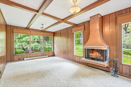 The large windows offer a beautiful view all year long and the copper fireplace adds to the charm