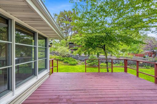 The view from the deck is enhanced by shade trees, gardens and a new retaining wall recently installed by the neighbors.