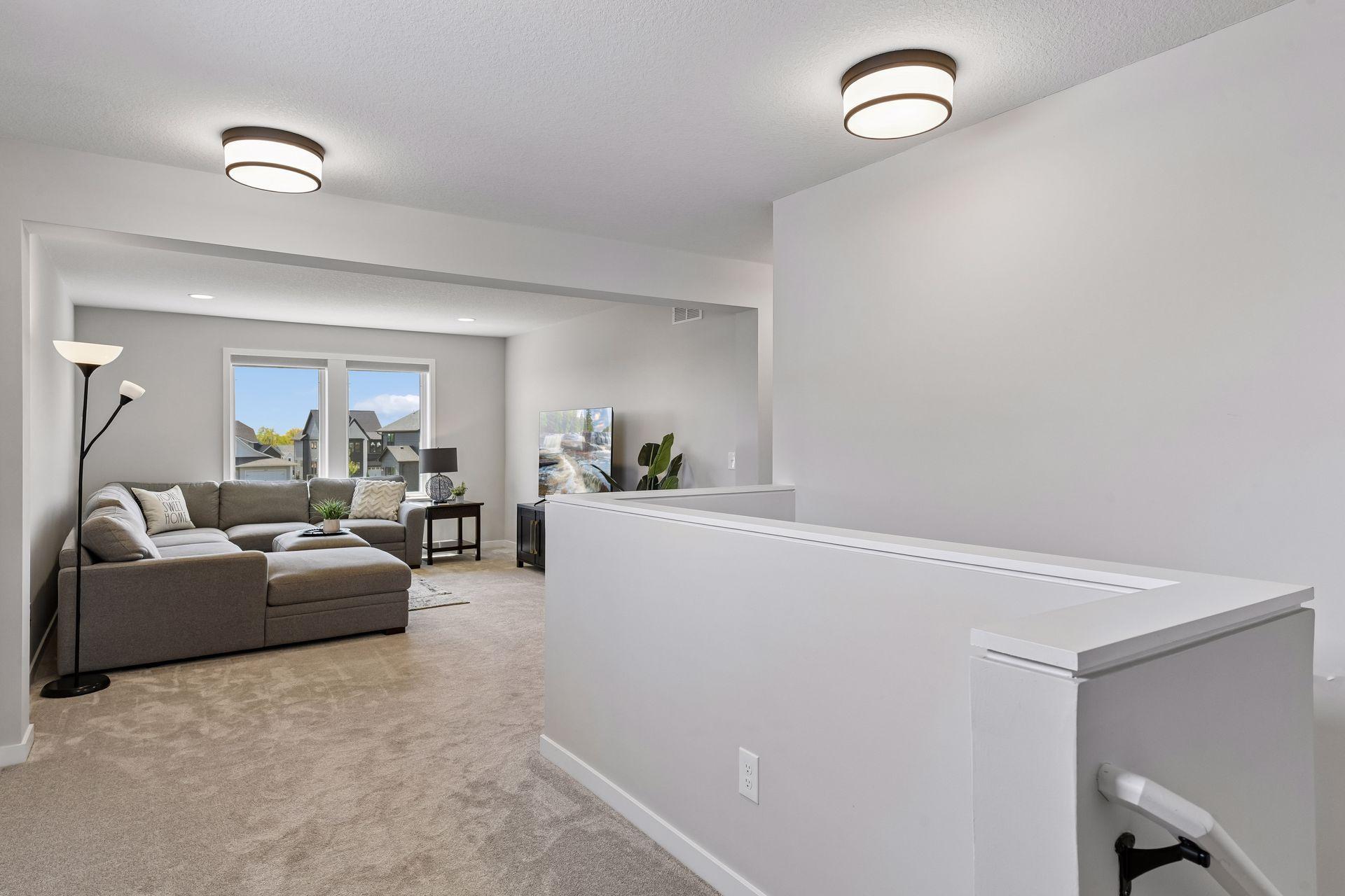 Spacious upper level bonus room offers flexible living space for a media room, playroom, homework zone, or relaxed second gathering room.