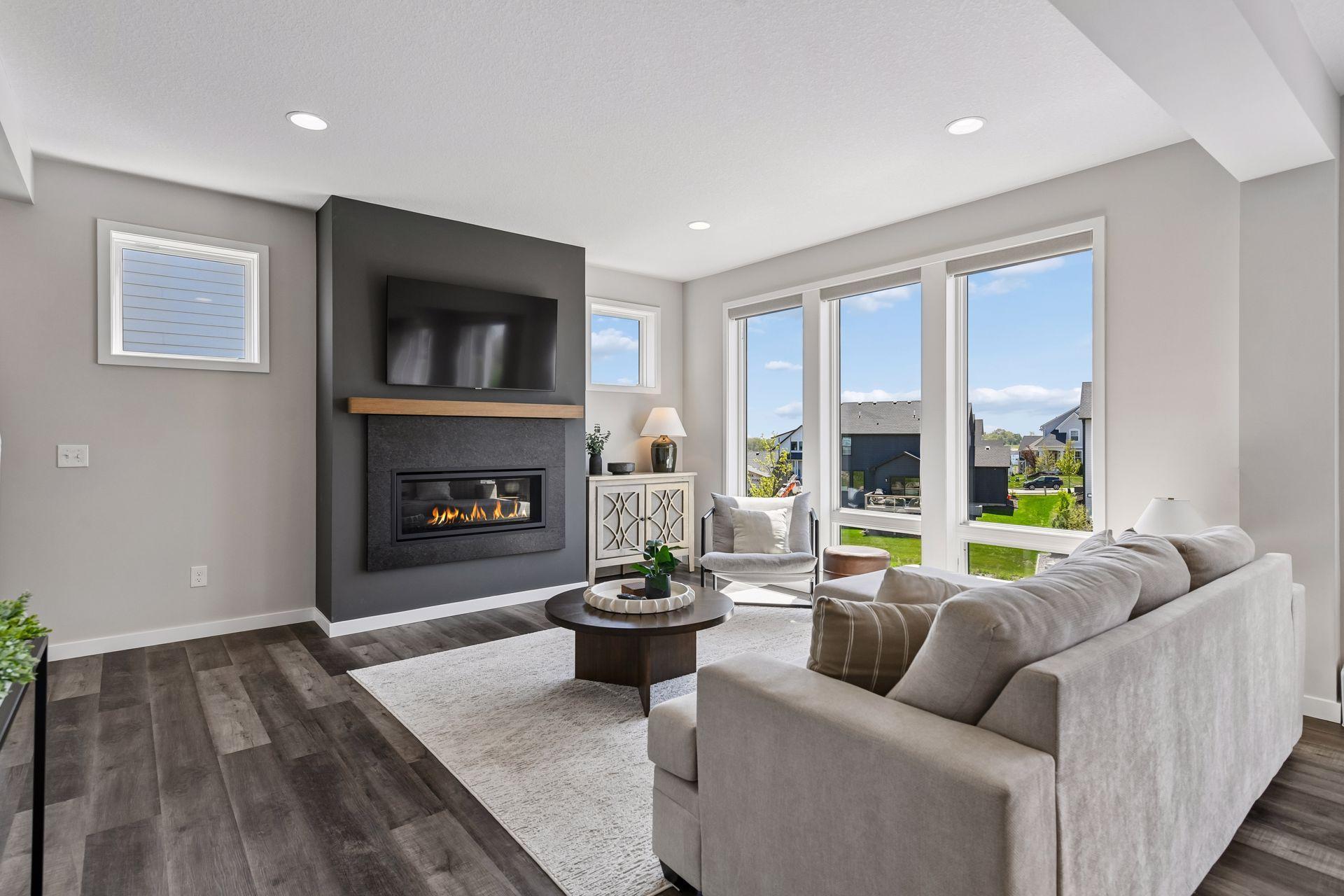 A sleek fireplace anchors the open concept main level.