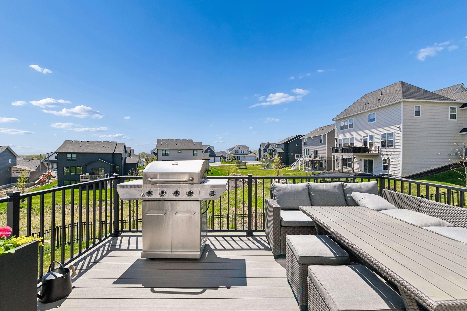 Maintenance-free deck extends the living space outdoors with plenty of room to grill, dine, relax, and enjoy Huntersbrook's open-sky neighborhood views.