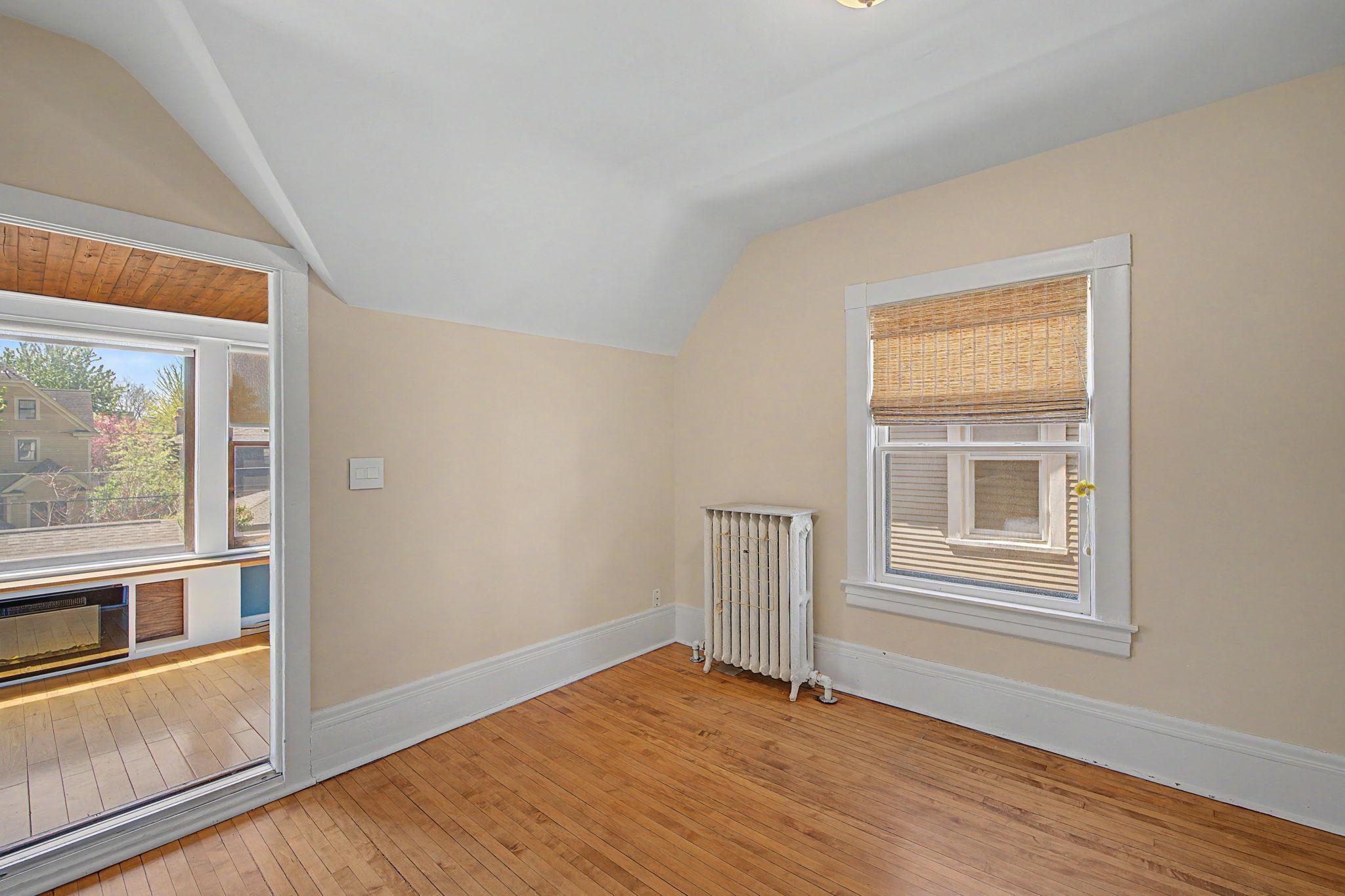 Upper level bedroom with sunroom.