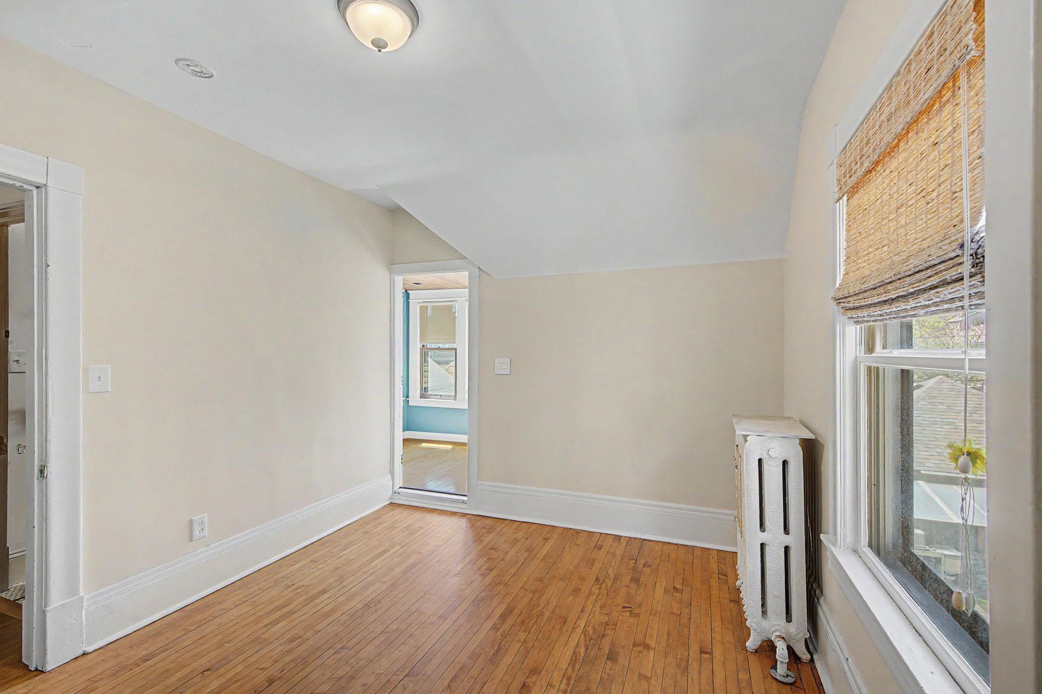 Upper level bedroom with entrance into the sunroom.