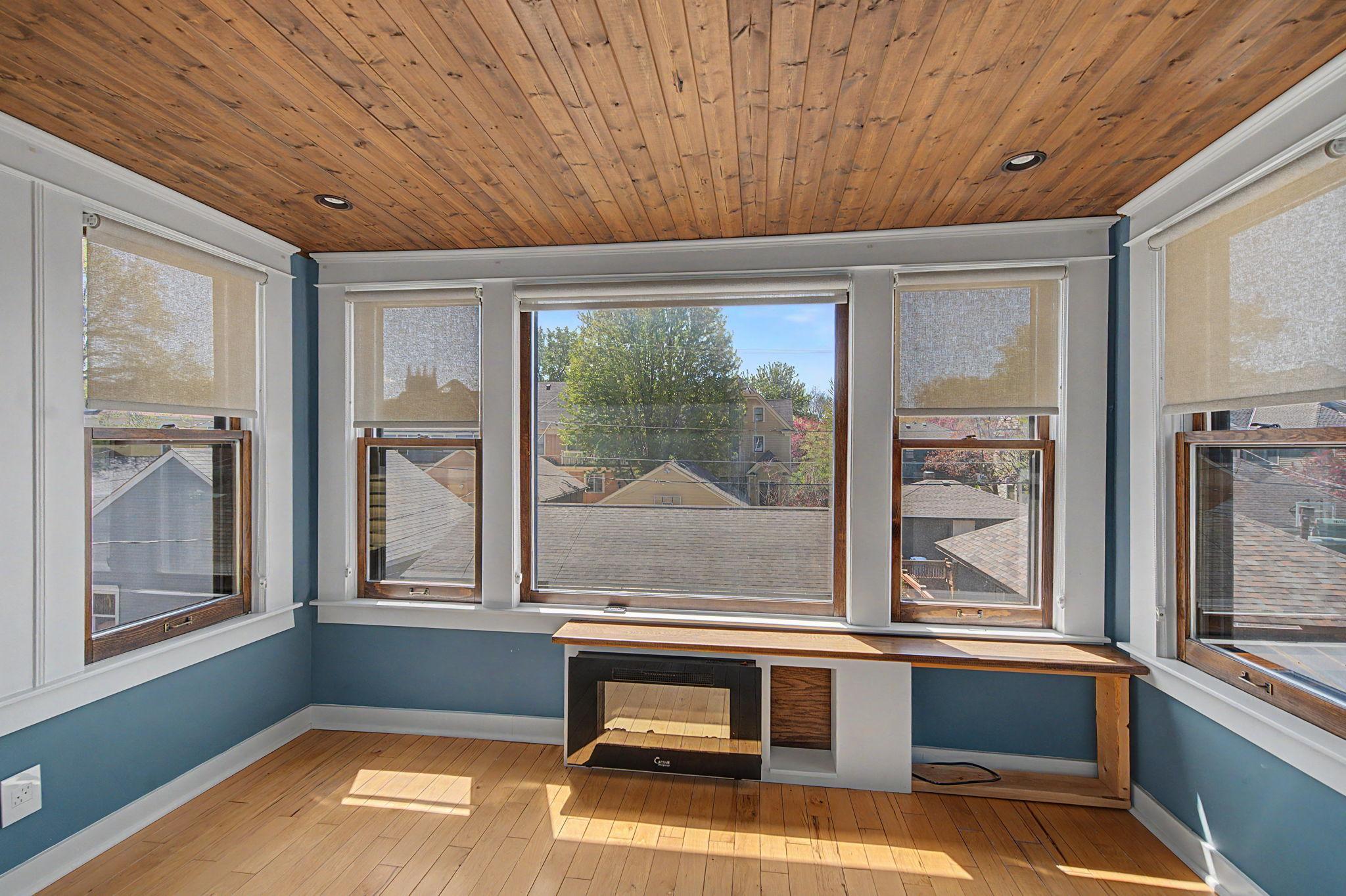 Sunroom with electric fireplace.
