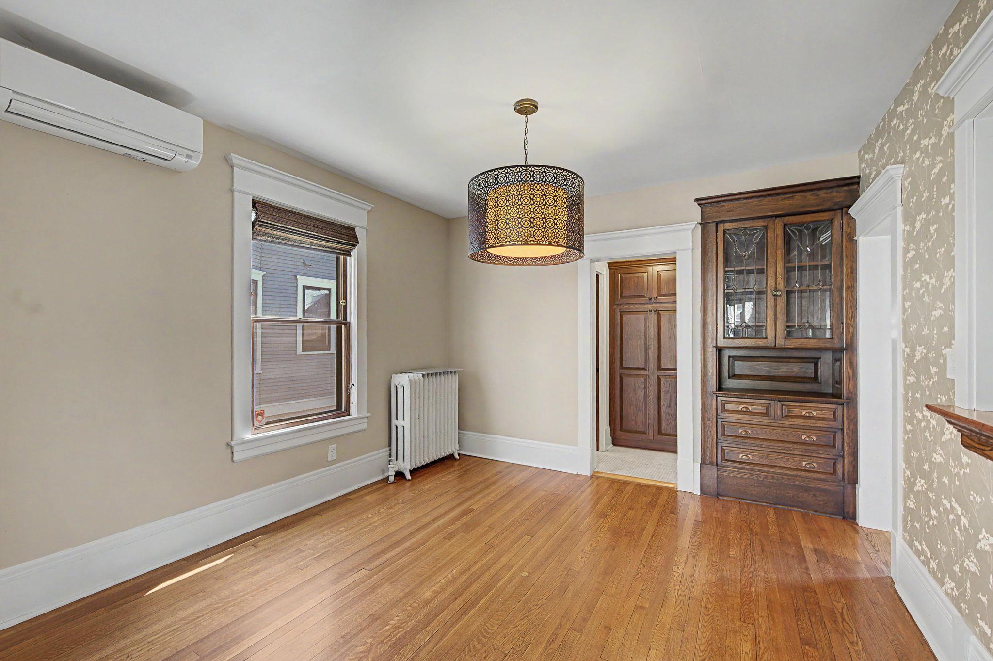 Hallway from the dining room has extra cabinet space and the guest bathroom.
