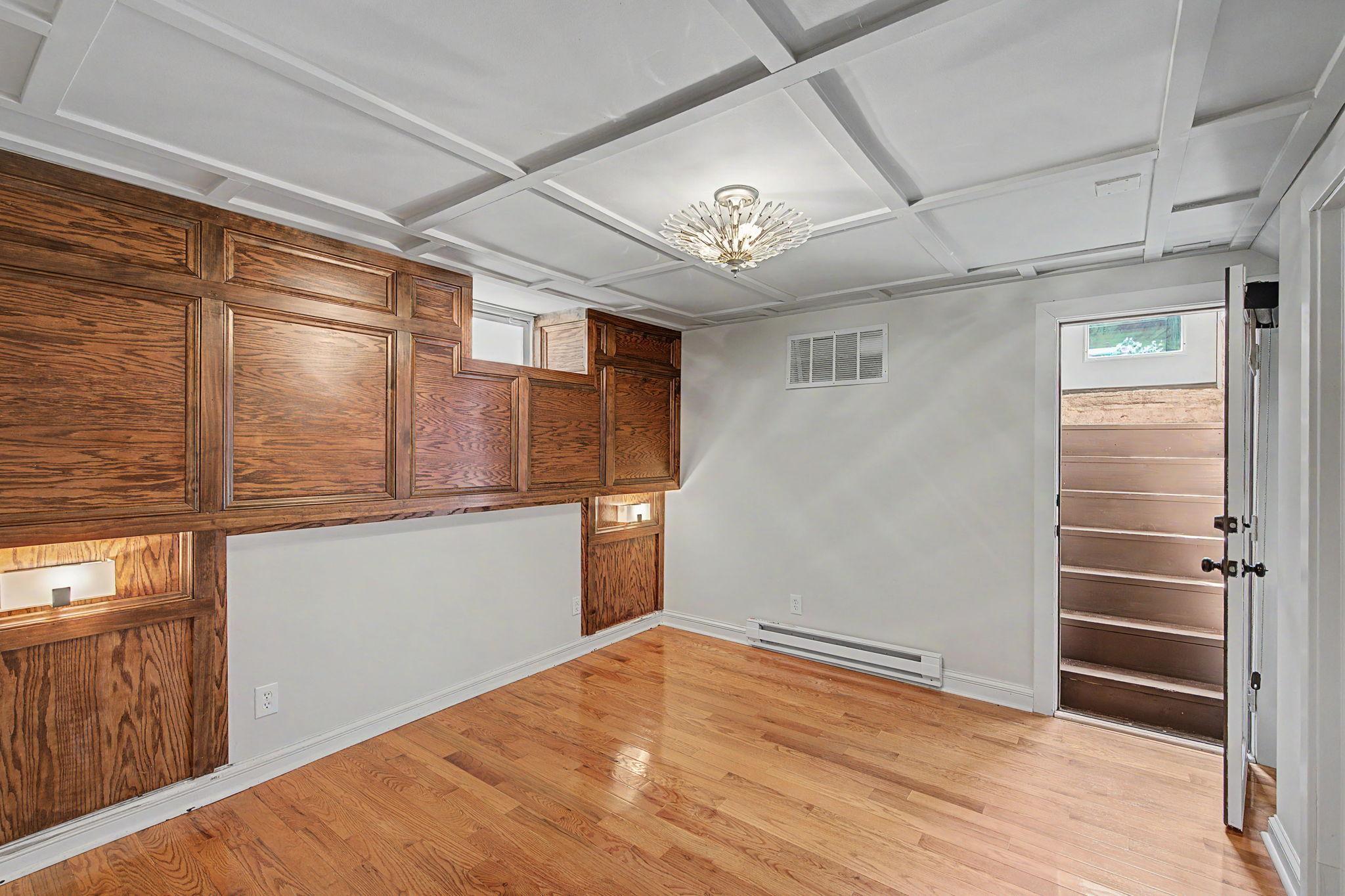 The lower level primary suite features stairs that lead directly to the backyard.