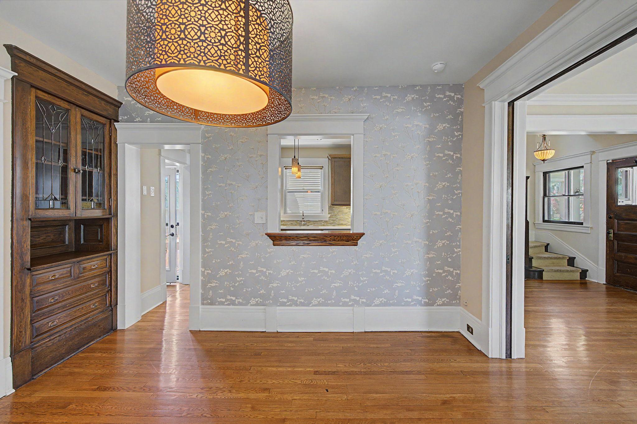 Pass through window from the kitchen into the dining room. The dining room also features classic built in cabinets.