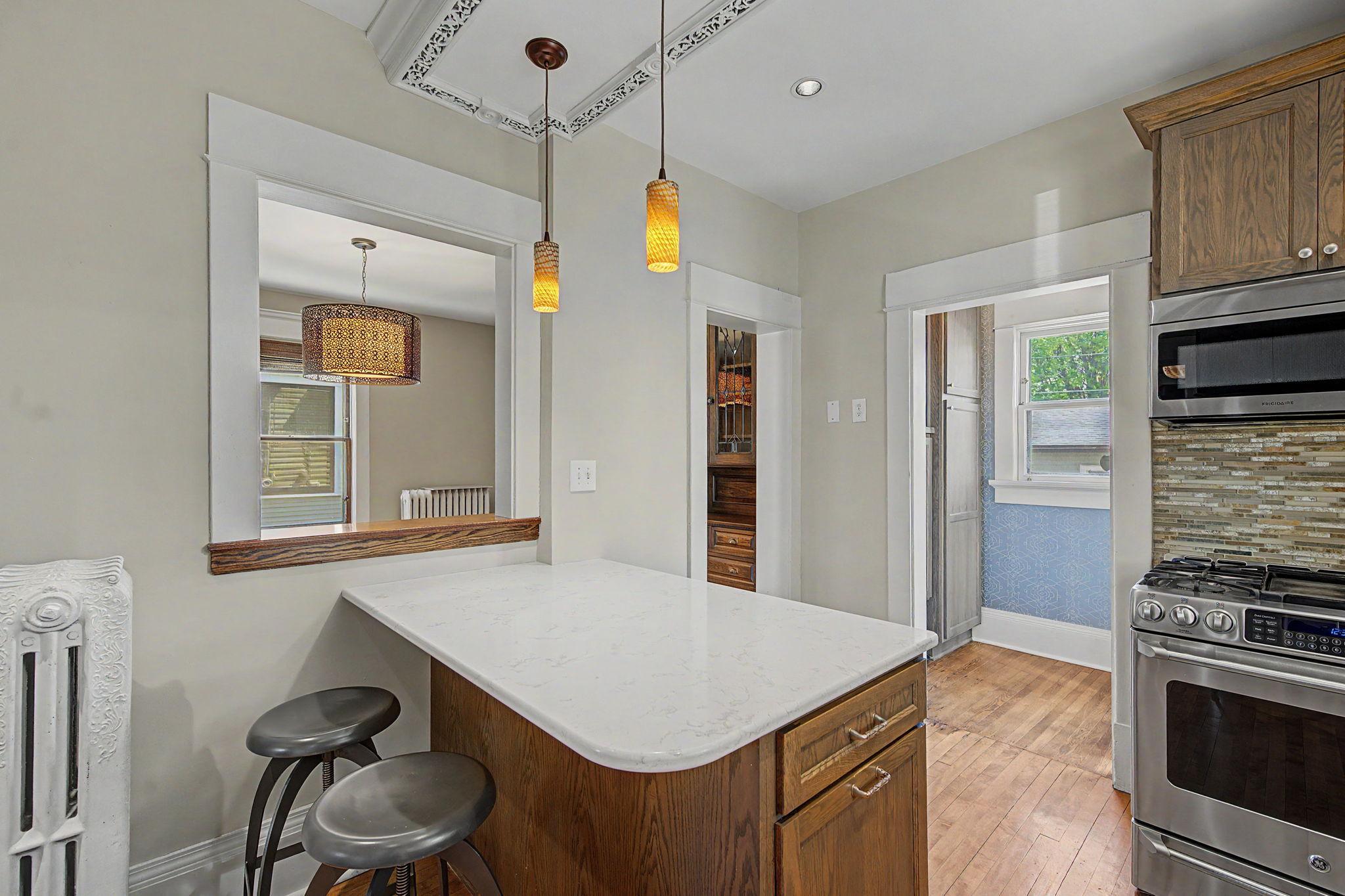 The kitchen also has a center island and a clever pass-through to the formal dining room makes hosting a breeze.